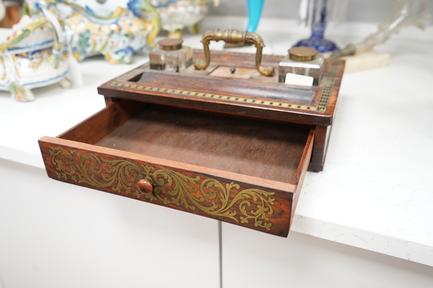 A George IV rosewood and cut brass inlaid two desk top inkstand, 29cm wide x 22cm deep